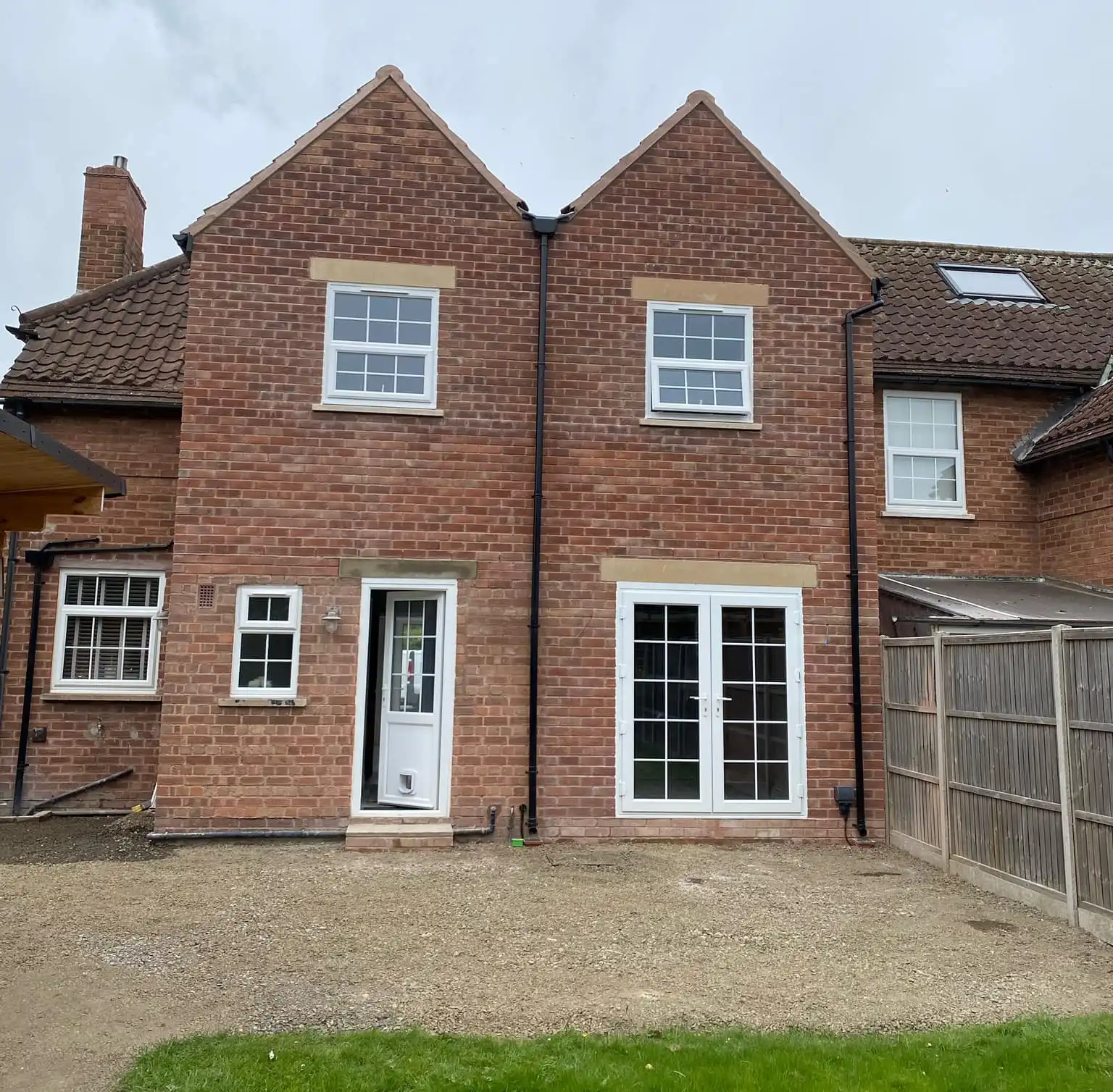 Two-story house extension showing completed construction work